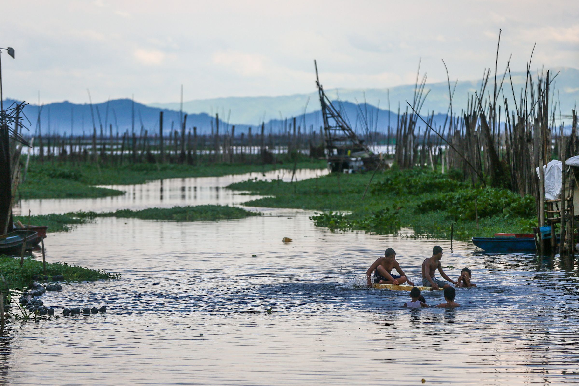 People take a dip at the Laguna de Bay on June 21, 2024. Jonathan Cellona, ABS-CBN News/File